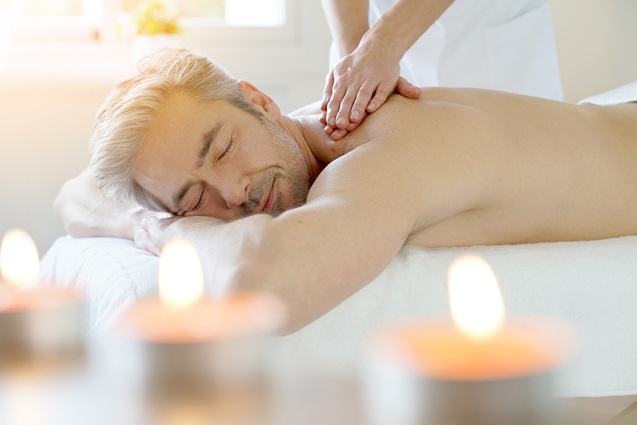 Man relaxing on massage table receiving massage