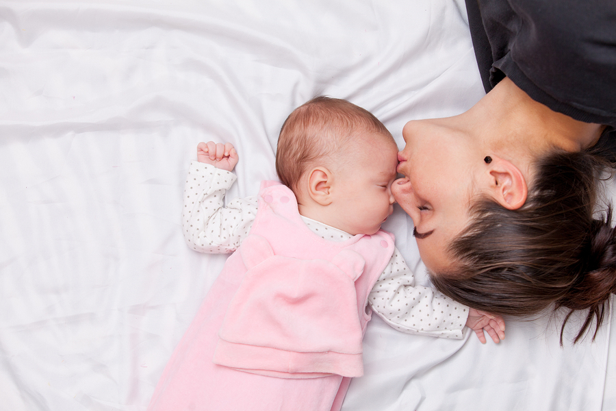 Mother and little baby in the bed