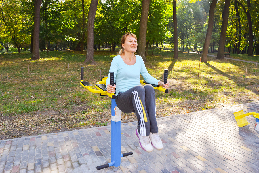 The girl is engaged in fitness in the park.